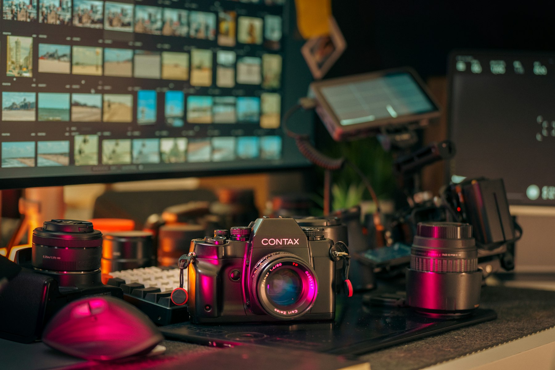 A creator's desk with cameras, lenses and editing monitors — the kind of footage StoryFuze turns into finished posts.